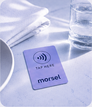 A lavender Morsel NFC card lying flat on a restaurant table